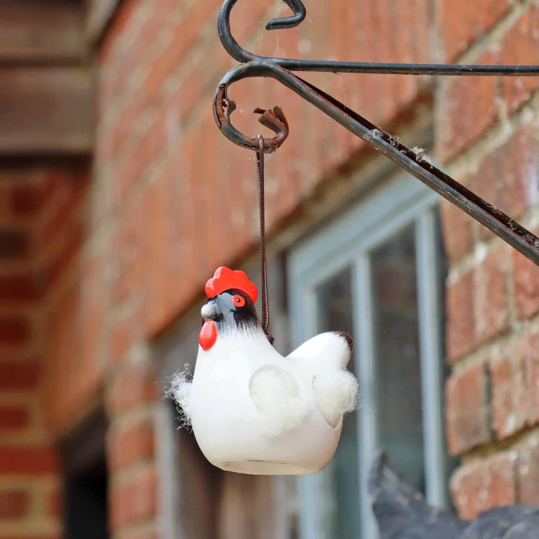 'Cluckie' hanging ceramic hen with nesting wool - Image 2